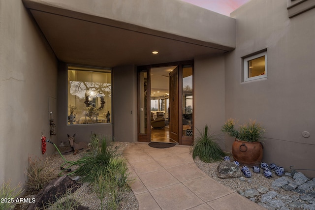 exterior entry at dusk with a patio area