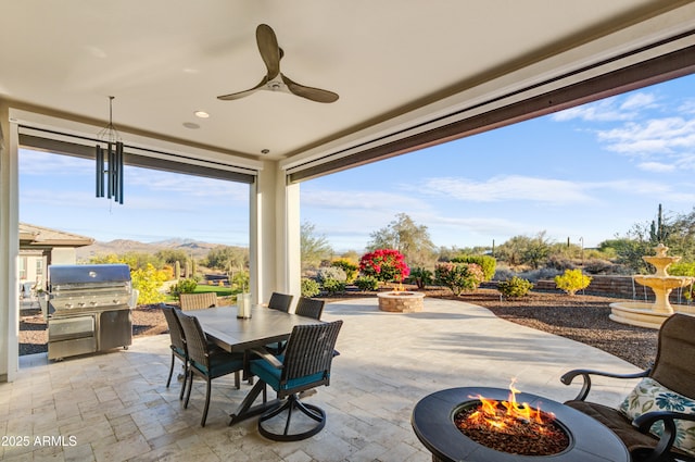 view of patio / terrace with a mountain view, area for grilling, a fire pit, and ceiling fan