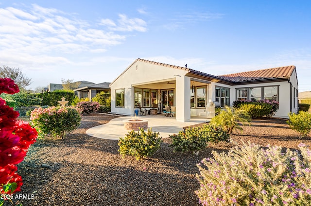 back of house featuring an outdoor fire pit, a patio area, and ceiling fan