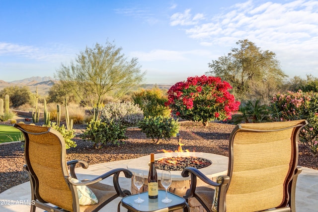 view of patio / terrace featuring a mountain view and an outdoor fire pit