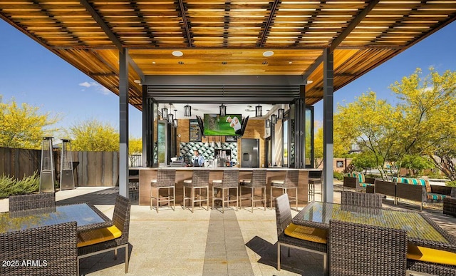 view of patio with an outdoor bar