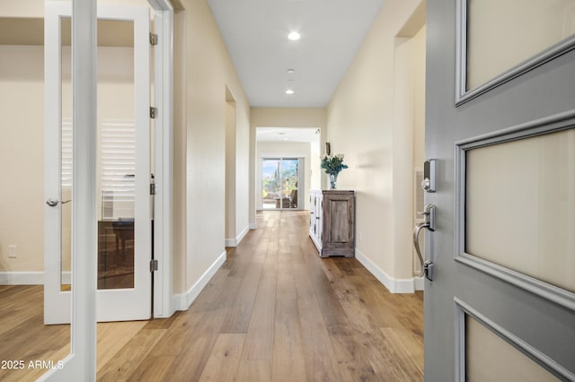 corridor with light wood-type flooring