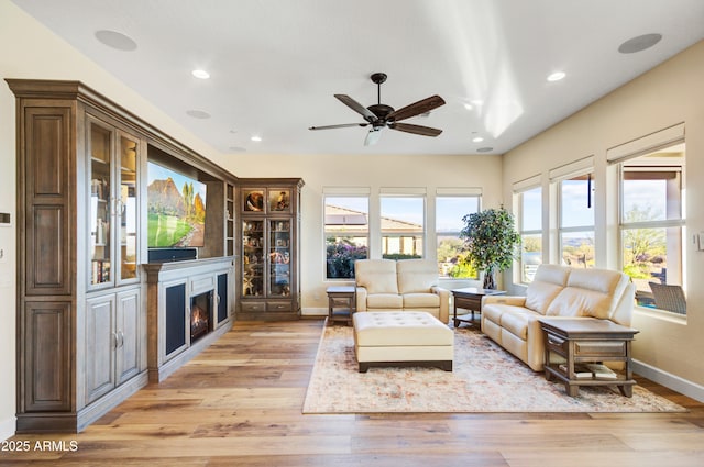 living room featuring light wood-type flooring and ceiling fan