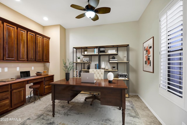 home office with baseboards and a ceiling fan