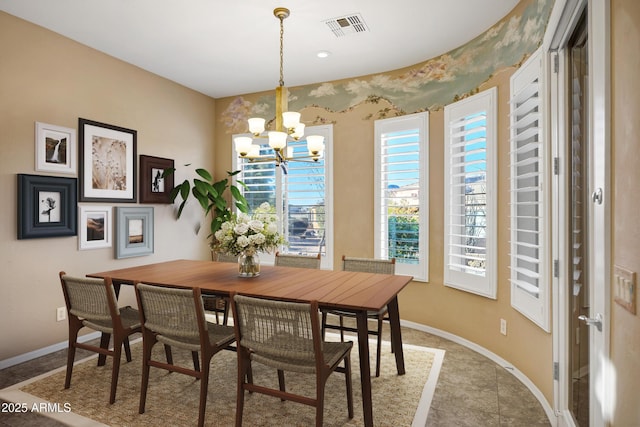 dining area with an inviting chandelier, baseboards, and visible vents