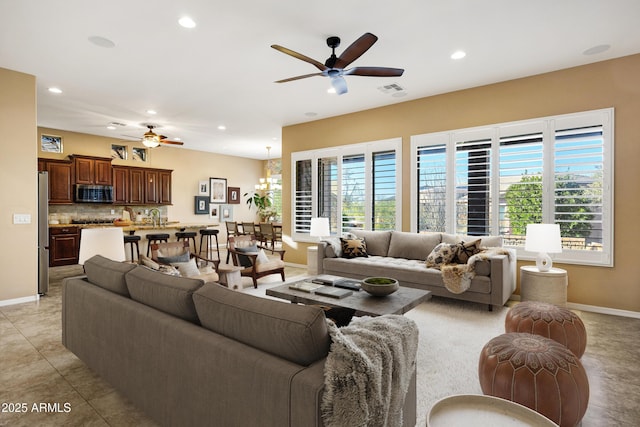 living room featuring recessed lighting, a healthy amount of sunlight, and baseboards