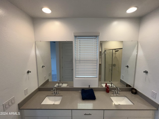 bathroom featuring vanity and an enclosed shower