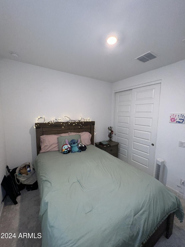 carpeted bedroom featuring a closet