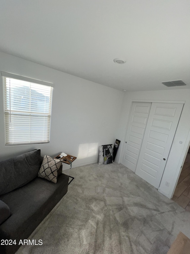 living area with light colored carpet