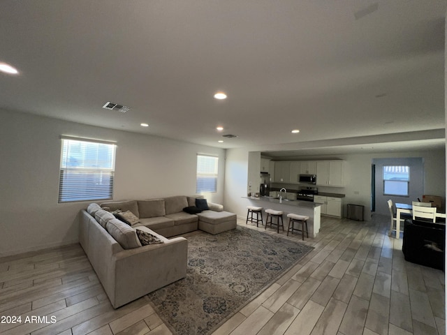 living room with a healthy amount of sunlight and light wood-type flooring