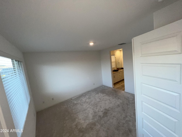 interior space with vaulted ceiling and carpet floors