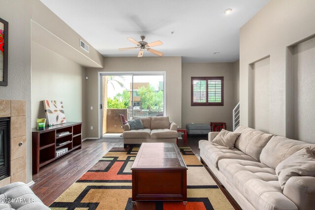 6745 N 93rd Ave Unit 1129, Glendale, AZ 85305 - living room featuring a ceiling fan, wood finished floors, and a fireplace