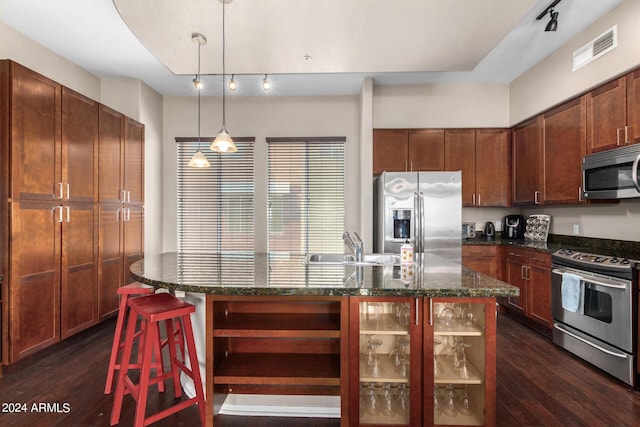 6745 N 93rd Ave Unit 1129, Glendale, AZ 85305 - kitchen with stainless steel appliances, track lighting, dark wood-style floors, and a center island