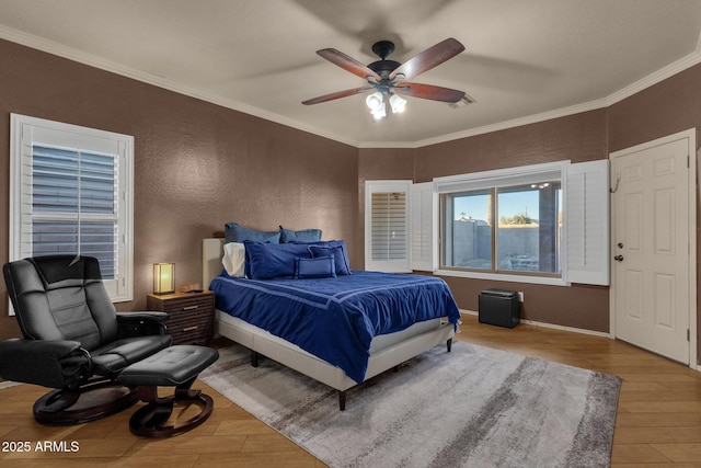 bedroom featuring ceiling fan, light hardwood / wood-style floors, and ornamental molding