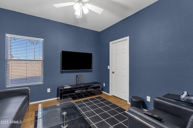 living room with wood-type flooring and ceiling fan