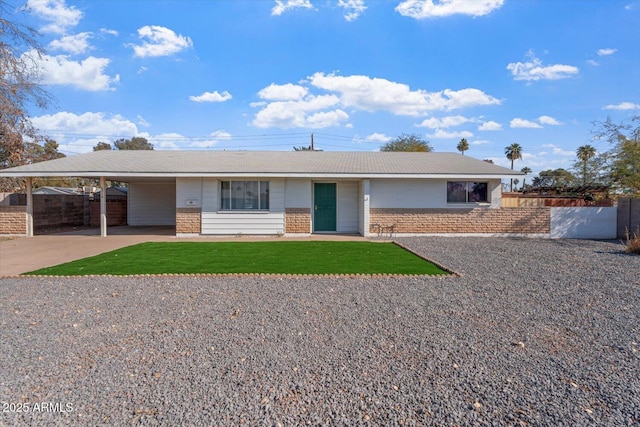 ranch-style home featuring a front yard and a carport