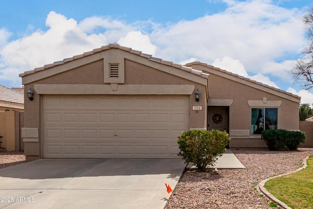 view of front of house with a garage, concrete driveway, and stucco siding