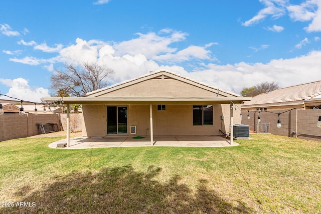 back of house featuring a lawn and a fenced backyard