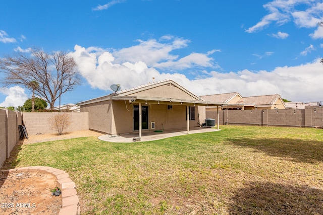 back of house featuring a patio, a fenced backyard, central air condition unit, a lawn, and stucco siding