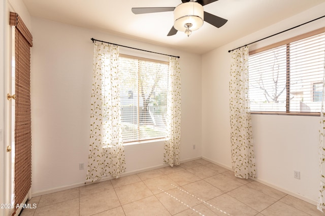 unfurnished room with ceiling fan and light tile patterned floors