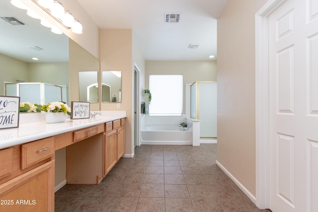 bathroom featuring tile patterned flooring, vanity, and shower with separate bathtub