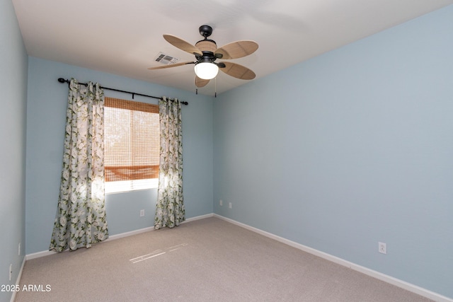 unfurnished room featuring ceiling fan and carpet