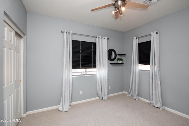 unfurnished room with light carpet, ceiling fan, and a healthy amount of sunlight