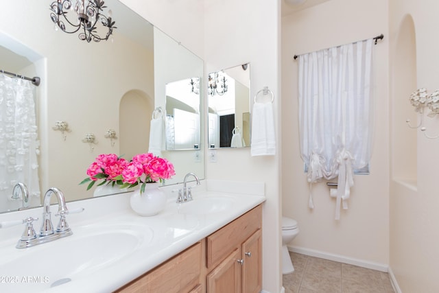 bathroom featuring vanity, tile patterned floors, and toilet