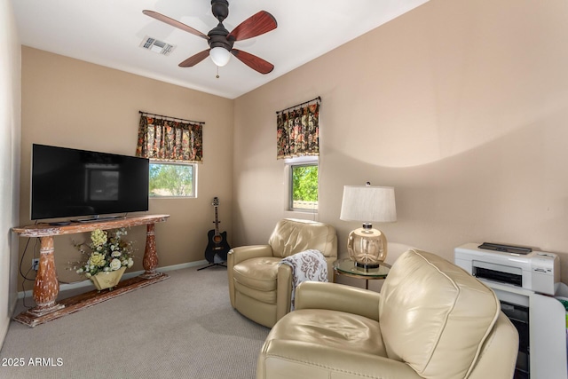 carpeted living room with ceiling fan