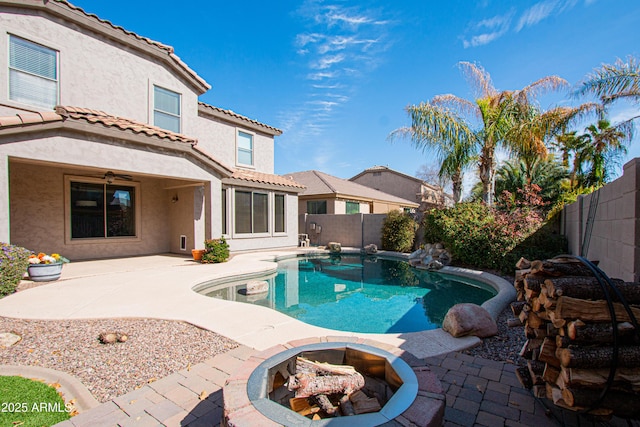 view of pool with a fire pit and a patio area