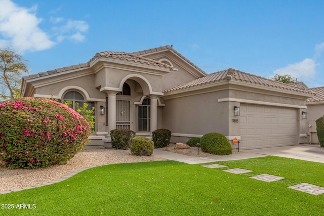 mediterranean / spanish house with a garage and a front yard