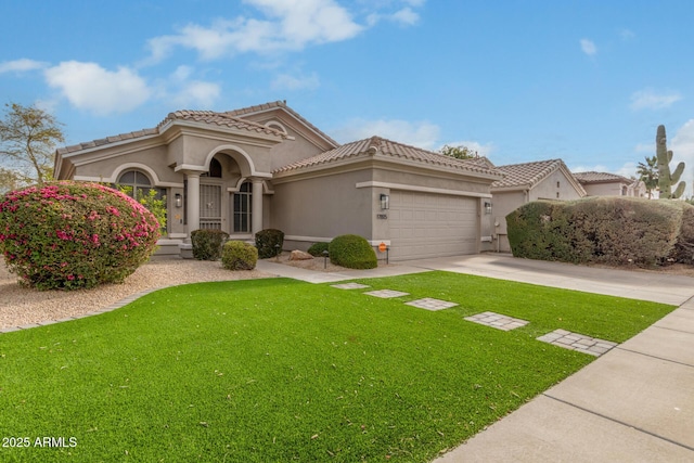 mediterranean / spanish house featuring a garage and a front yard