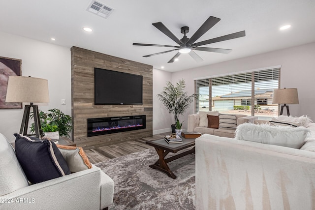 living room featuring a fireplace, ceiling fan, and hardwood / wood-style floors