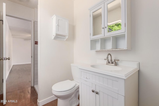 bathroom with vanity, hardwood / wood-style flooring, and toilet