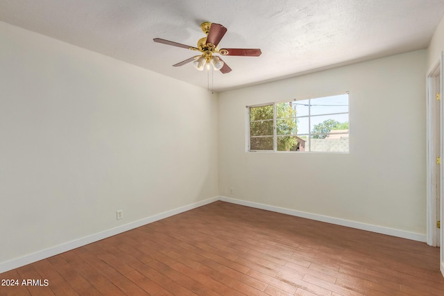 empty room with ceiling fan and wood-type flooring