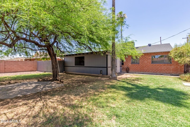 rear view of house with a yard