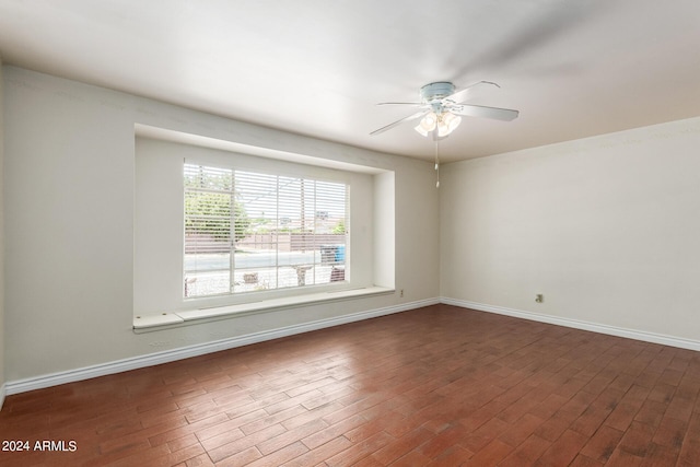 unfurnished room with dark hardwood / wood-style floors and ceiling fan