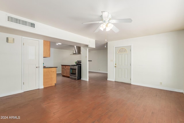 unfurnished living room with ceiling fan and dark hardwood / wood-style floors