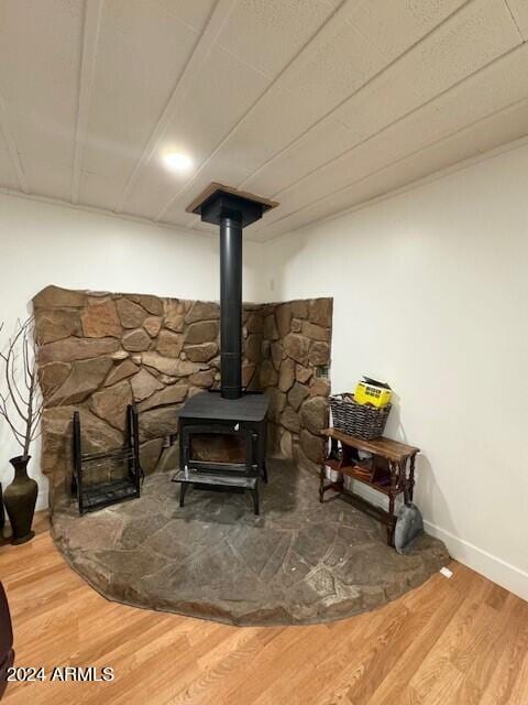 details featuring hardwood / wood-style flooring and a wood stove