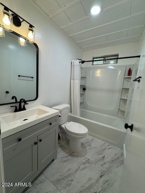 full bathroom with shower / tub combo with curtain, vanity, tile floors, and toilet