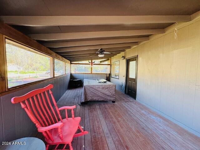 wooden deck featuring ceiling fan