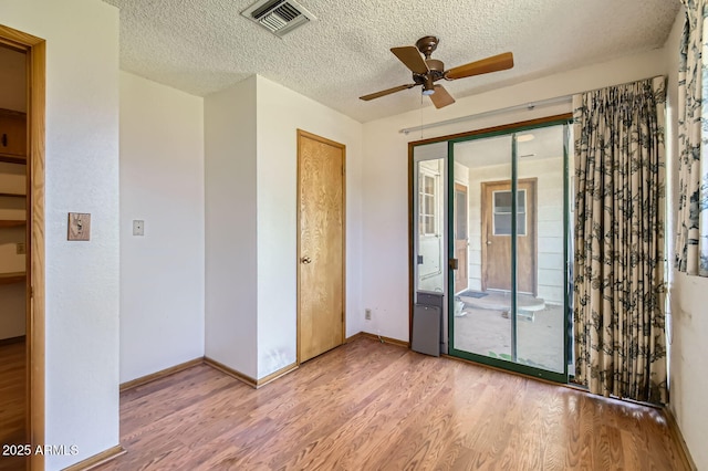 3944 E Oak St, Phoenix, AZ 85008 - spare room featuring wood finished floors, ceiling fan, and a textured ceiling