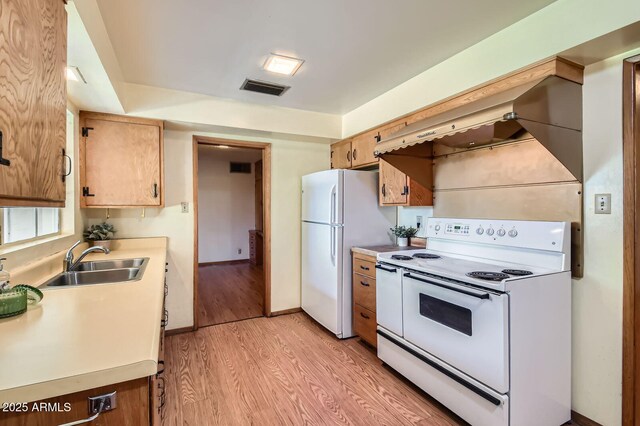 3944 E Oak St, Phoenix, AZ 85008 - kitchen featuring white appliances, light wood finished floors, light countertops, and custom range hood