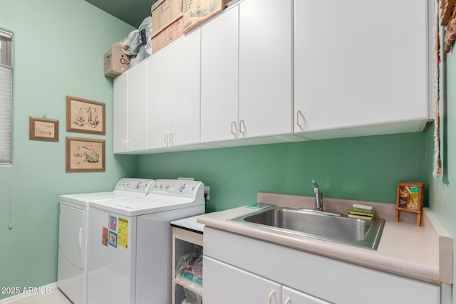 laundry area with cabinets, separate washer and dryer, and sink