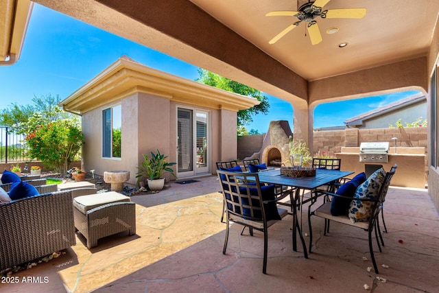 view of patio / terrace featuring ceiling fan, a fenced backyard, area for grilling, an outdoor kitchen, and outdoor dining space