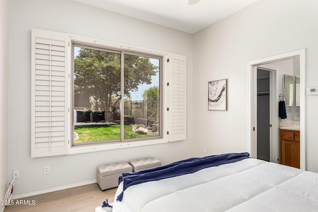 bedroom with baseboards and wood finished floors