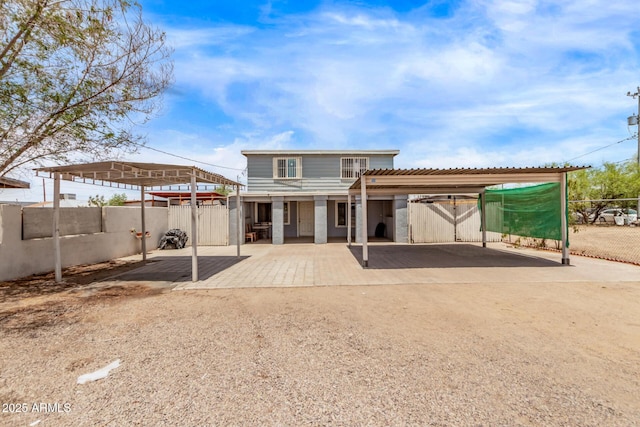 3702 W Sherman St, Phoenix, AZ 85009 - back of house with driveway and a detached carport