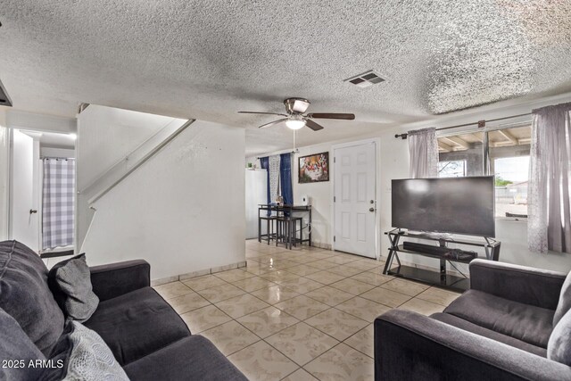 3702 W Sherman St, Phoenix, AZ 85009 - living room featuring ceiling fan, light tile patterned floors, stairway, a textured ceiling, and baseboards