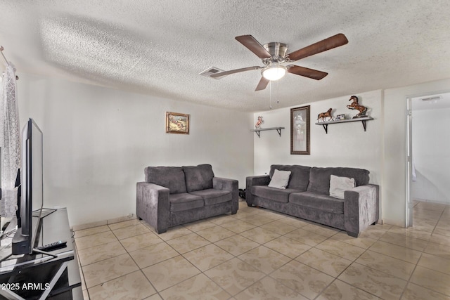 3702 W Sherman St, Phoenix, AZ 85009 - living room featuring light tile patterned floors, ceiling fan, and a textured ceiling