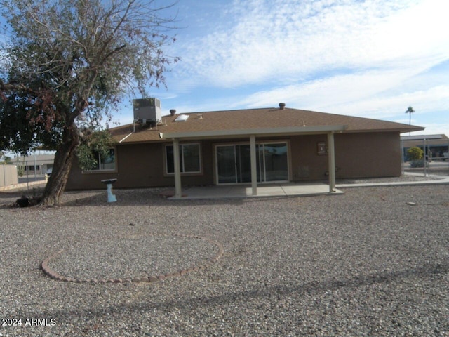 back of property featuring cooling unit and a patio